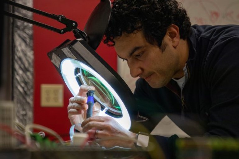 IU researcher Amrou Awaysheh works on a smart meter that will be placed in a manufacturing facility to monitor energy use