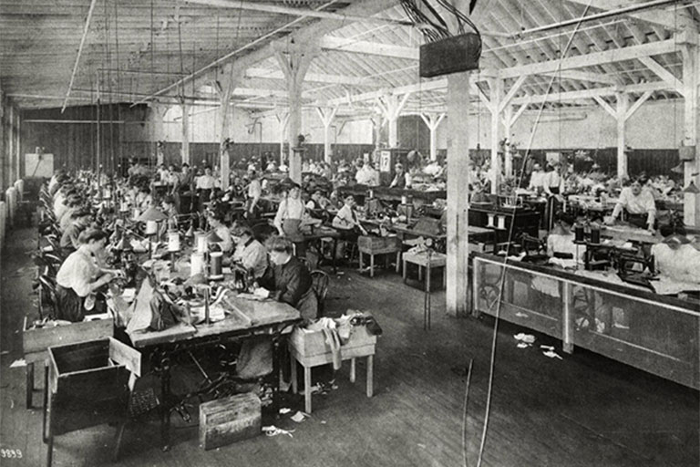 A historic black and white photo of a clothing factory