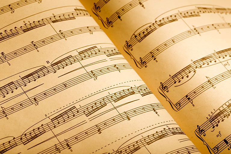 Closeup of an open music book showing notation for a song