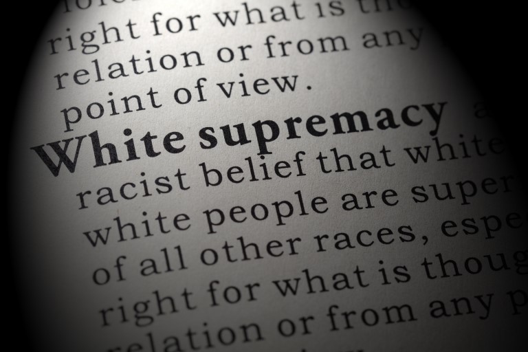 The page of a book with the words "White supremacy" bolded for focus